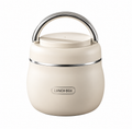 Cream-colored insulated lunch box with a stainless steel handle and a silver metallic band, featuring a 'LUNCH BOX' label on the front.