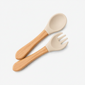 A baby feeding utensil set consisting of a wooden spoon and fork with beige silicone heads, shown on a plain white background.